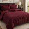 Five-piece queen size quilt set in burgundy.