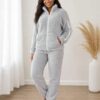 Womens cozy fleece lounge set featuring a zip-up jacket and matching pants.